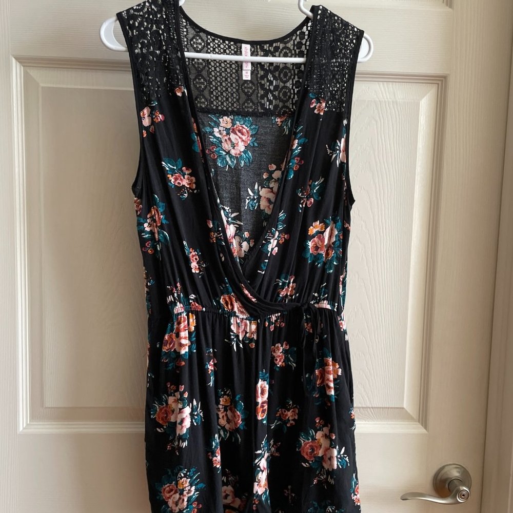 Black floral romper with button closure at chest